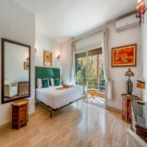 Marrakech concierge: key opening a decorated wooden door with lantern – Your Host Marrakech