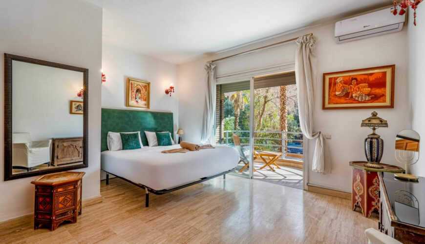 Marrakech concierge: key opening a decorated wooden door with lantern – Your Host Marrakech